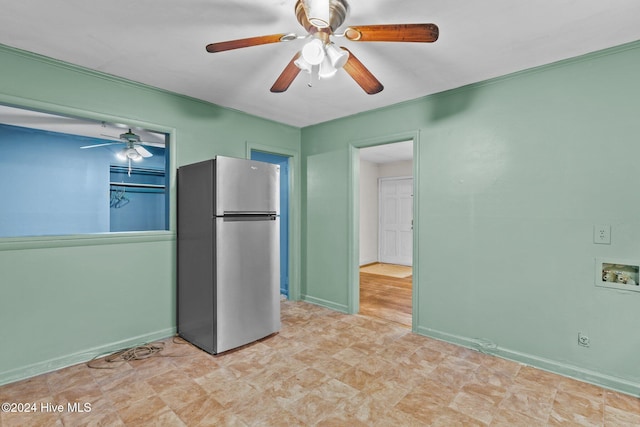 interior space featuring stainless steel fridge and ceiling fan