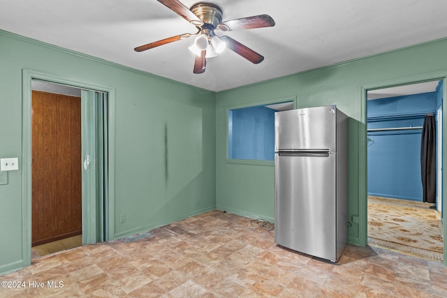 interior space with stainless steel fridge and ceiling fan