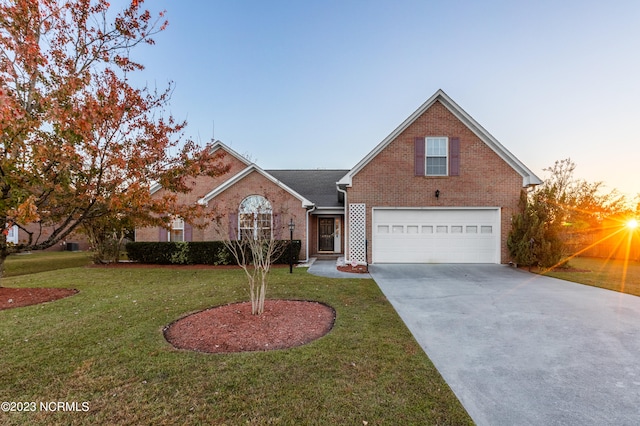 front facade with a garage and a lawn