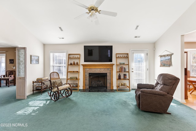 living room featuring a fireplace, a wealth of natural light, and vaulted ceiling