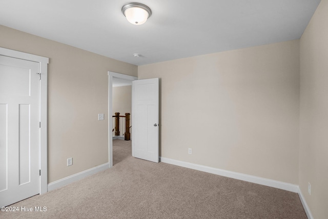 unfurnished bedroom featuring light colored carpet