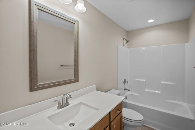 full bathroom featuring toilet, washtub / shower combination, and vanity