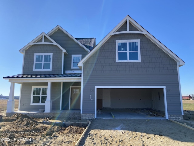 view of front of house featuring a porch and a garage