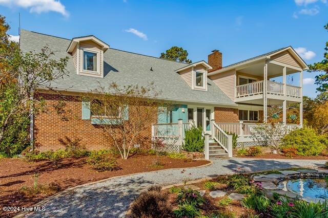 view of front of property with a balcony and a porch