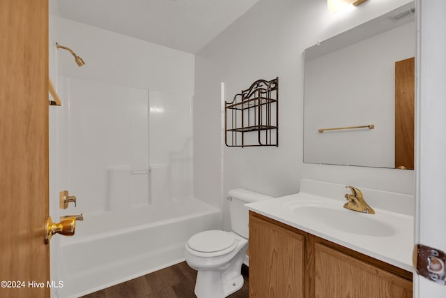 full bathroom featuring vanity, a textured ceiling, bathing tub / shower combination, wood-type flooring, and toilet