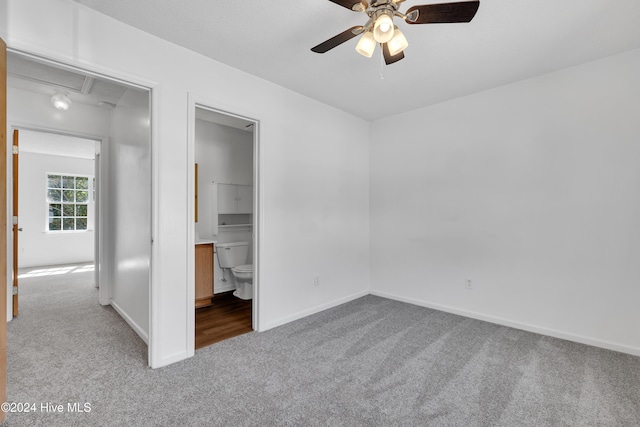 unfurnished bedroom with ensuite bath, ceiling fan, and light carpet