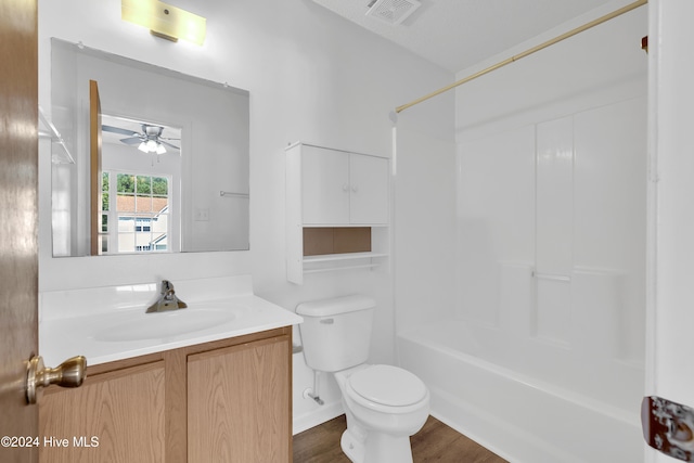 full bathroom featuring vanity, shower / washtub combination, ceiling fan, wood-type flooring, and toilet