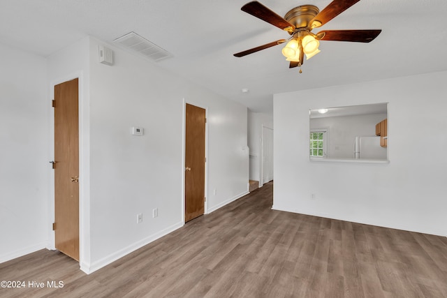 unfurnished room featuring ceiling fan and light hardwood / wood-style flooring