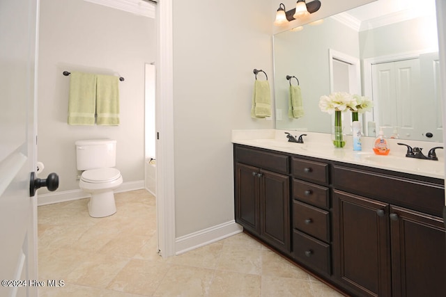 bathroom with toilet, tile patterned flooring, crown molding, and vanity