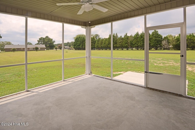 unfurnished sunroom featuring ceiling fan