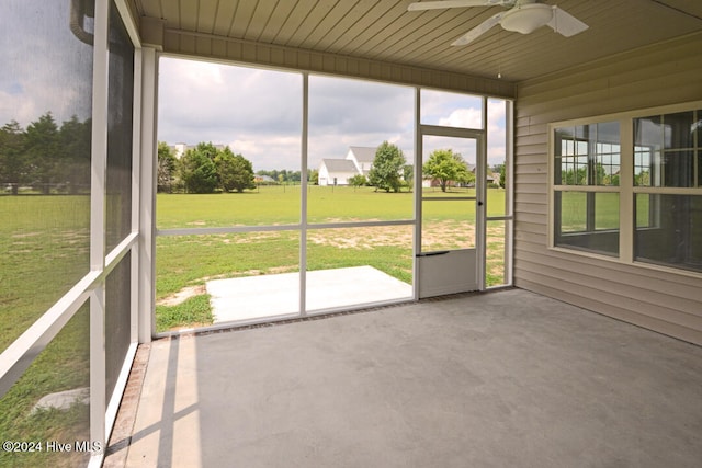 unfurnished sunroom with ceiling fan