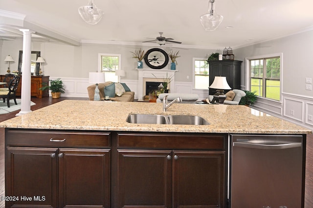 kitchen with ornamental molding, pendant lighting, stainless steel dishwasher, and sink