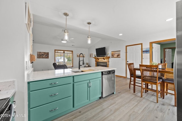 kitchen featuring sink, dishwasher, green cabinetry, and light wood-type flooring