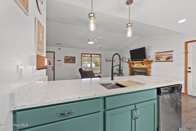 kitchen with stainless steel dishwasher, ceiling fan, sink, wood-type flooring, and lofted ceiling