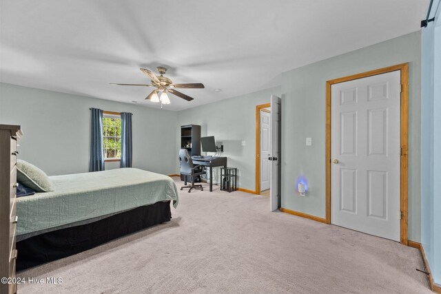 bedroom featuring ceiling fan and light colored carpet