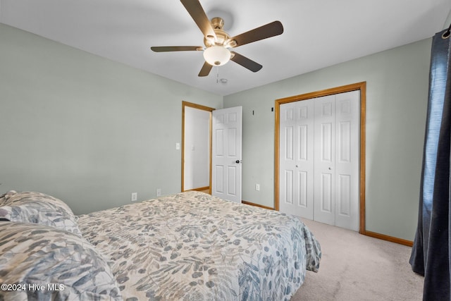 carpeted bedroom with a closet and ceiling fan