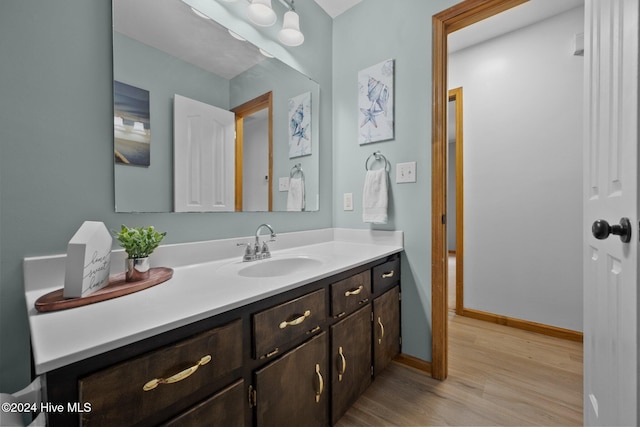 bathroom with vanity and hardwood / wood-style flooring