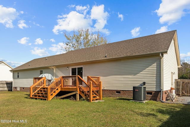 back of property featuring central air condition unit, a lawn, and a wooden deck