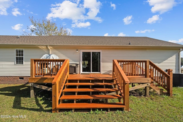 back of property with a deck and a yard