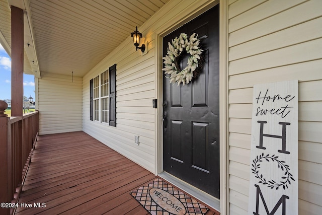 view of exterior entry featuring a porch