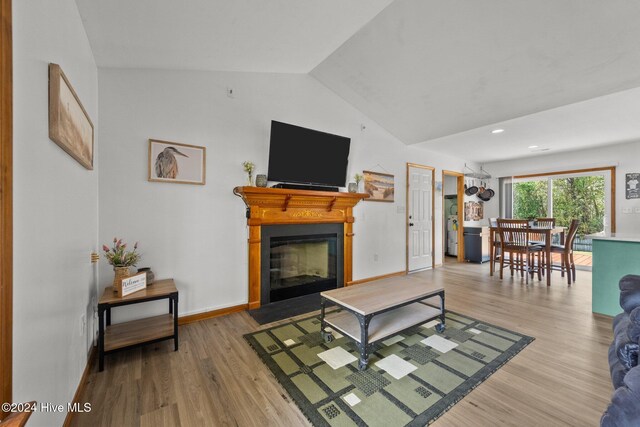 living room with hardwood / wood-style floors and vaulted ceiling