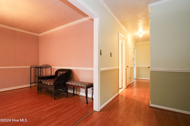 hall with crown molding and hardwood / wood-style flooring