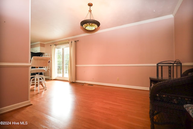 interior space featuring ornamental molding and light hardwood / wood-style flooring