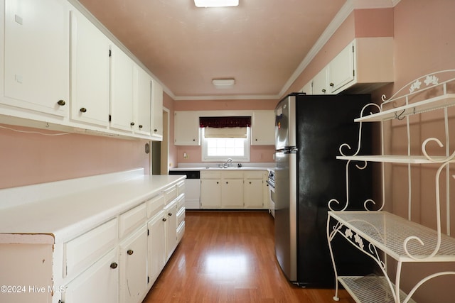 kitchen featuring dishwasher, hardwood / wood-style floors, white cabinets, and stainless steel refrigerator