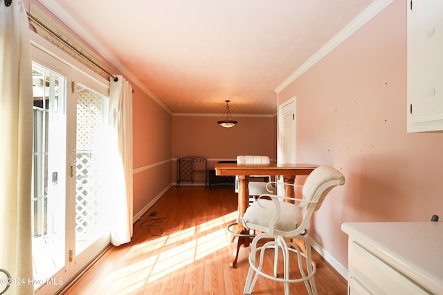 dining room featuring hardwood / wood-style floors and ornamental molding