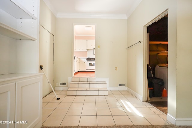 corridor with light tile patterned floors and crown molding