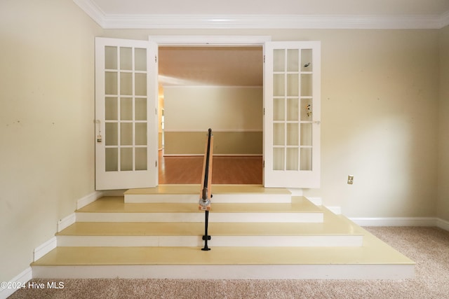 staircase featuring carpet floors and crown molding