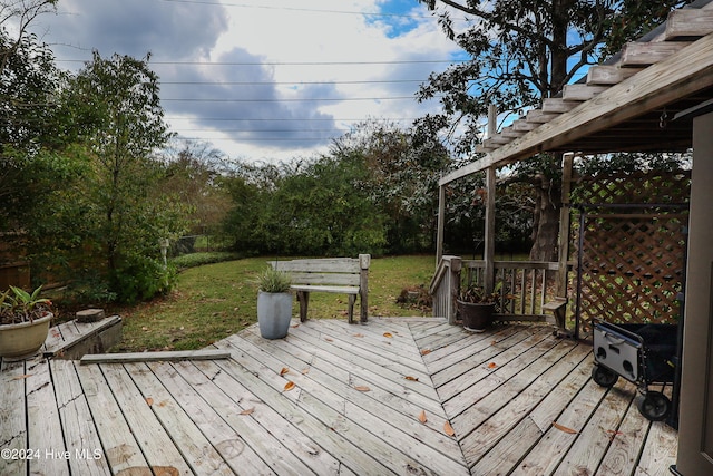 wooden terrace featuring a yard