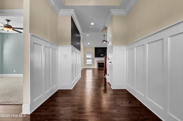 hallway featuring dark wood-type flooring and ornamental molding