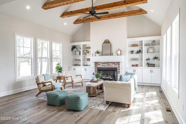 unfurnished bedroom featuring light wood finished floors, a barn door, baseboards, ensuite bath, and recessed lighting