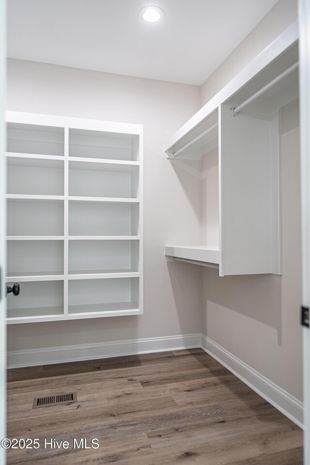 bonus room with lofted ceiling, baseboards, and wood finished floors