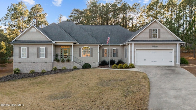 view of front of home with a garage and a front lawn