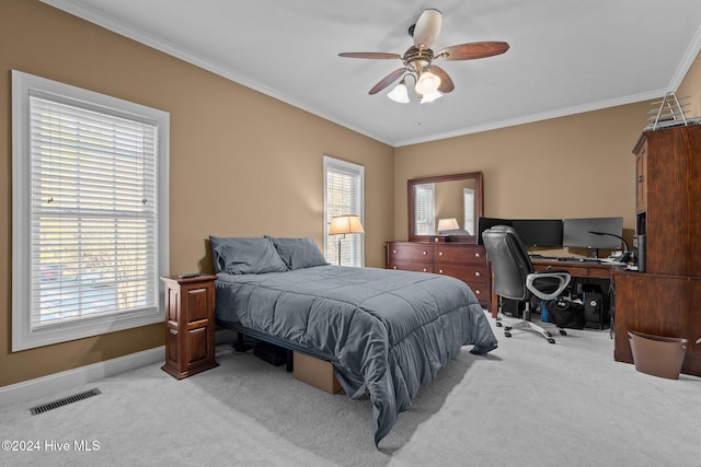 bedroom with ceiling fan, crown molding, and light carpet