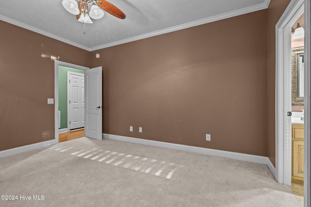 unfurnished bedroom with light colored carpet, ceiling fan, and ornamental molding