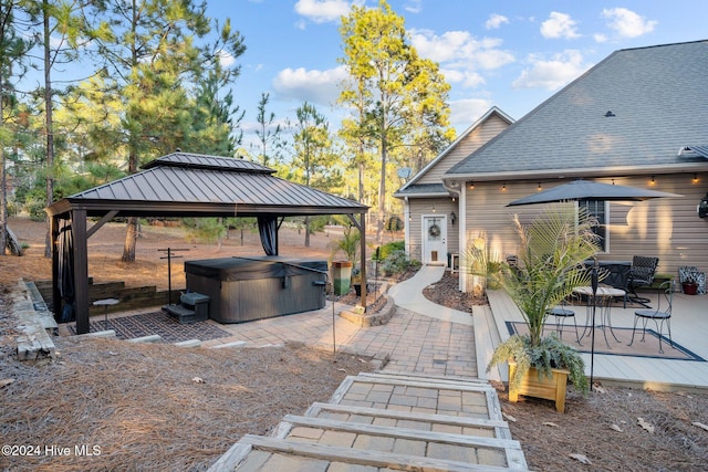 view of patio / terrace with a gazebo and a hot tub