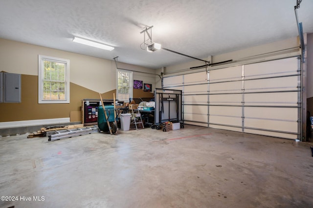 garage featuring electric panel and a garage door opener