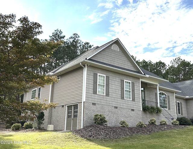 view of home's exterior with a porch and a yard