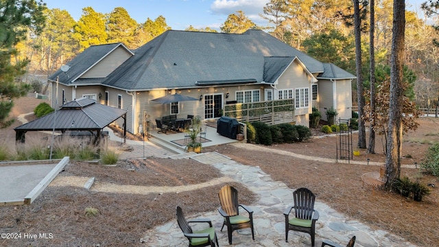 rear view of property with a gazebo and a patio area