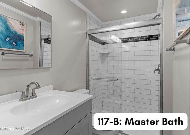 full bathroom featuring ornamental molding, a stall shower, vanity, and toilet