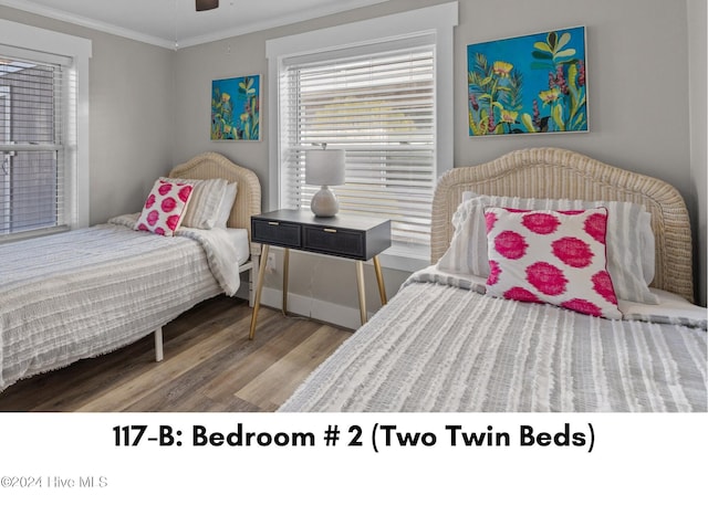 bedroom with hardwood / wood-style flooring and ornamental molding