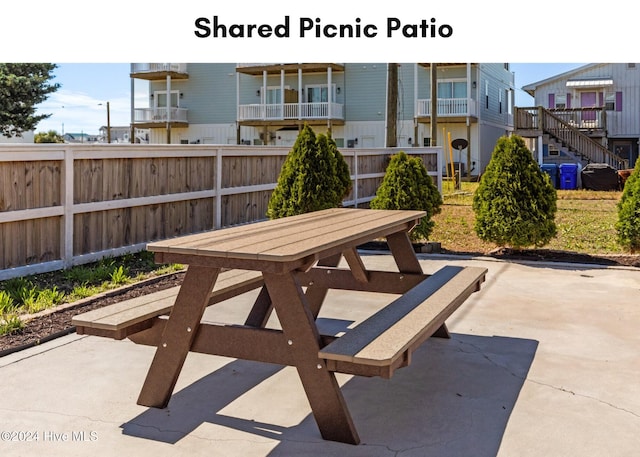 view of patio / terrace with a residential view, outdoor dining area, and fence