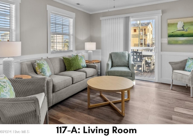 living room featuring hardwood / wood-style floors and ornamental molding