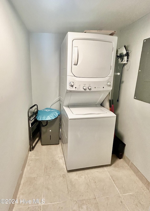 washroom with electric panel and stacked washing maching and dryer