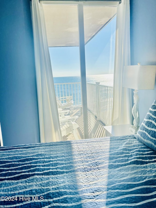 bedroom featuring a water view