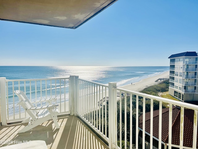 balcony with a beach view and a water view