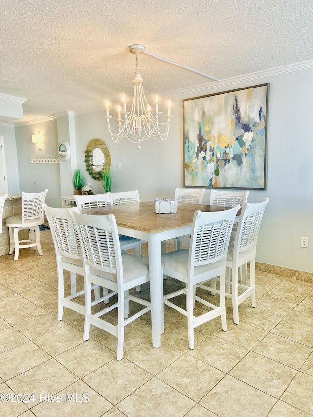 dining area with ornamental molding, a textured ceiling, a notable chandelier, and light tile patterned flooring